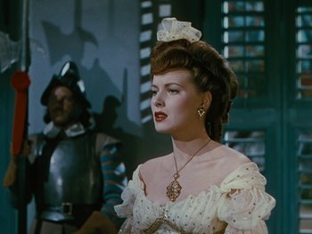 Movie still from “The Black Swan” (1942), directed by Henry King – A woman in a white dress and a man in a black suit; Close Up shot, Over the shoulder angle