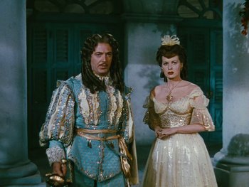 Movie still from “The Black Swan” (1942), directed by Henry King – A man and a woman dressed as beauty and the beast; Medium shot, Low angle