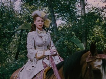 Movie still from “The Black Swan” (1942), directed by Henry King – A woman dressed in period clothing riding a horse; Medium shot, Low angle