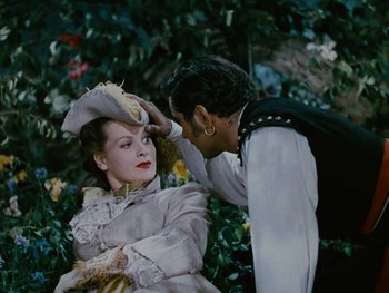 Movie still from “The Black Swan” (1942), directed by Henry King – A man and a woman in period clothing; Medium shot, Over the shoulder angle