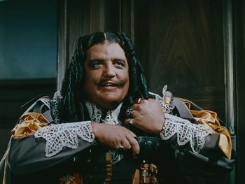 Movie still from “The Black Swan” (1942), directed by Henry King – A man with long black hair wearing a wig; Close Up shot, High angle