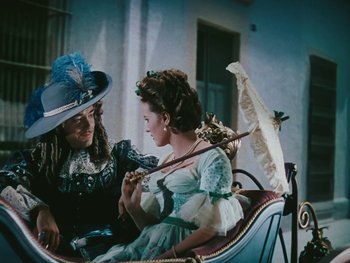 Movie still from “The Black Swan” (1942), directed by Henry King – Two women sitting in a carriage on a sunny day; Medium shot, High angle