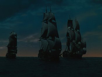 Movie still from “The Black Swan” (1942), directed by Henry King – A group of ships sailing on a body of water at night; Extreme Wide shot, High angle