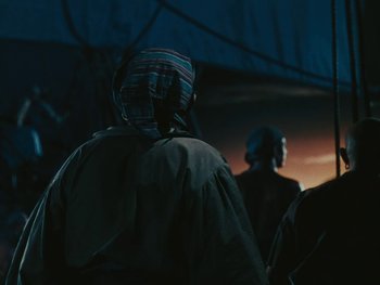 Movie still from “The Black Swan” (1942), directed by Henry King – A person wearing a hat and a jacket; Medium shot, Low angle