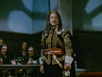 Movie still from “The Black Swan” (1942), directed by Henry King – A man dressed as a pirate stands in front of two other men; Medium shot, Over the shoulder angle