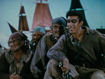 Movie still from “The Black Swan” (1942), directed by Henry King – A group of men standing next to each other; Medium shot, High angle