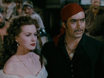 Movie still from “The Black Swan” (1942), directed by Henry King – A man and a woman standing next to each other; Close Up shot, Low angle