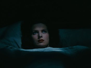Movie still from “The Black Swan” (1942), directed by Henry King – A woman laying in a bed under a blanket; Close Up shot, Overhead angle