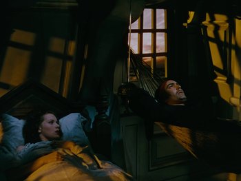 Movie still from “The Black Swan” (1942), directed by Henry King – A man and a woman laying in a bed; Wide shot, Overhead angle