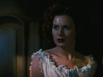 Movie still from “The Black Swan” (1942), directed by Henry King – A woman with red hair and blue eyes wearing a white dress; Close Up shot, Low angle