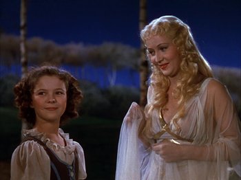 Movie still from “The Blue Bird” (1940), directed by Walter Lang – A young girl standing next to an older woman; Medium shot, Low angle