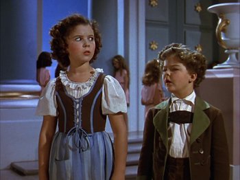 Movie still from “The Blue Bird” (1940), directed by Walter Lang – A young girl and a young boy standing next to each other; Medium shot, Low angle