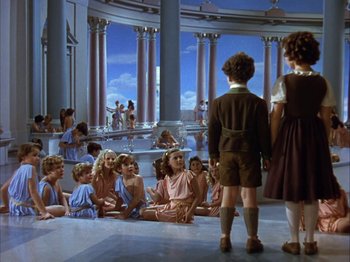 Movie still from “The Blue Bird” (1940), directed by Walter Lang – A group of children sitting on the floor of a building; Wide shot, High angle