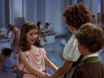 Movie still from “The Blue Bird” (1940), directed by Walter Lang – A group of young people holding hands in a room; Medium shot, Over the shoulder angle