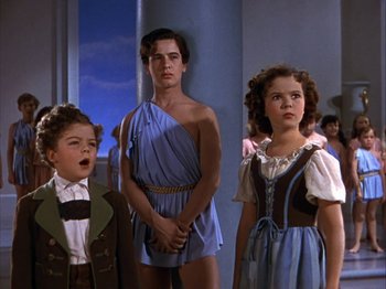 Movie still from “The Blue Bird” (1940), directed by Walter Lang – A group of young people standing next to each other; Medium shot, Low angle