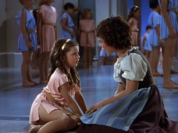 Movie still from “The Blue Bird” (1940), directed by Walter Lang – Two young girls are sitting on the floor; Medium shot, High angle