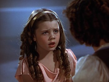Movie still from “The Blue Bird” (1940), directed by Walter Lang – A little girl with long hair is looking at another girl with long hair; Close Up shot, High angle