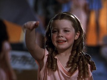 Movie still from “The Blue Bird” (1940), directed by Walter Lang – A little girl that is holding her hand up in the air; Close Up shot, Low angle
