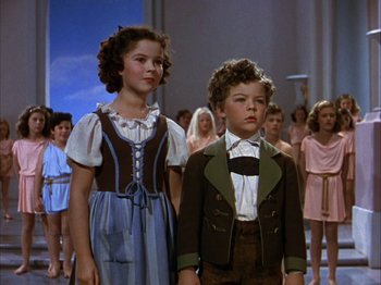 Movie still from “The Blue Bird” (1940), directed by Walter Lang – A couple of children standing next to each other; Medium shot, Low angle