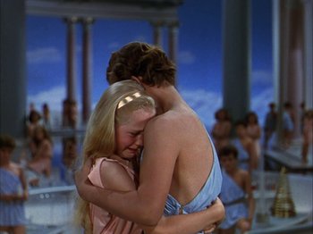 Movie still from “The Blue Bird” (1940), directed by Walter Lang – Two people hugging each other in front of a crowd; Medium shot, High angle