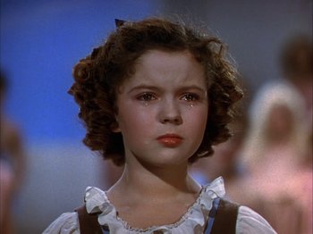 Movie still from “The Blue Bird” (1940), directed by Walter Lang – A little girl with curly brown hair crying; Close Up shot, High angle