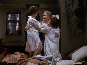 Movie still from “The Blue Bird” (1940), directed by Walter Lang – A woman and two children in a room; Wide shot, High angle