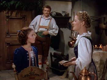 Movie still from “The Blue Bird” (1940), directed by Walter Lang – Two women and a man are talking in a kitchen; Medium shot, Over the shoulder angle