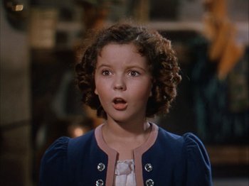Movie still from “The Blue Bird” (1940), directed by Walter Lang – A little girl with curly brown hair wearing a blue jacket; Close Up shot, High angle