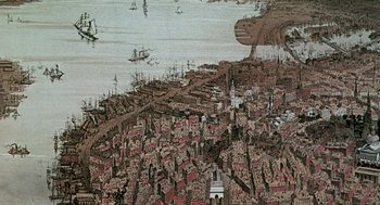 Movie still from “The Blue Lagoon” (1980), directed by Randal Kleiser – An aerial view of a city with boats in the water; Extreme Wide shot, Overhead angle