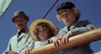 Movie still from “The Blue Lagoon” (1980), directed by Randal Kleiser – Two boys and an old man are on a boat; Close Up shot, Low angle