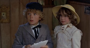 Movie still from “The Blue Lagoon” (1980), directed by Randal Kleiser – A boy and a little girl are looking at a piece of paper; Close Up shot, High angle