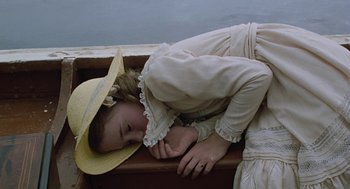 Movie still from “The Blue Lagoon” (1980), directed by Randal Kleiser – A girl in a straw hat is sleeping in a boat; Medium shot, Overhead angle