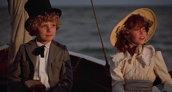 Movie still from “The Blue Lagoon” (1980), directed by Randal Kleiser – Two people sitting in a boat on the water; Close Up shot, Low angle