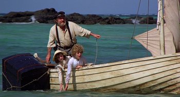 Movie still from “The Blue Lagoon” (1980), directed by Randal Kleiser – An old man and two children in a boat in the ocean; Wide shot, High angle