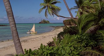 Movie still from “The Blue Lagoon” (1980), directed by Randal Kleiser – A small sail boat on the water near the shore; Extreme Wide shot, High angle