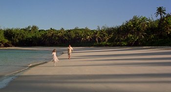 Movie still from “The Blue Lagoon” (1980), directed by Randal Kleiser – A man and a woman walking on the beach; Extreme Wide shot, High angle