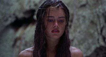 Movie still from “The Blue Lagoon” (1980), directed by Randal Kleiser – A young woman with wet hair and blue eyes; Close Up shot, Low angle