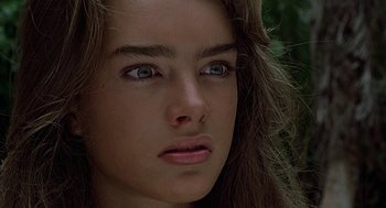 Movie still from “The Blue Lagoon” (1980), directed by Randal Kleiser – A young woman's face with green eyes; Close Up shot, High angle