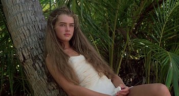 Movie still from “The Blue Lagoon” (1980), directed by Randal Kleiser – A beautiful young lady sitting on top of a tree; Close Up shot, Low angle