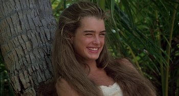 Movie still from “The Blue Lagoon” (1980), directed by Randal Kleiser – A young woman with long hair smiling for the camera; Close Up shot, High angle