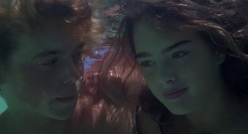 Movie still from “The Blue Lagoon” (1980), directed by Randal Kleiser – A woman and a man are underwater in the water; Close Up shot, Overhead angle