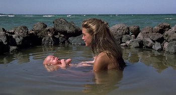 Movie still from “The Blue Lagoon” (1980), directed by Randal Kleiser – A woman and a baby in the water; Wide shot, High angle