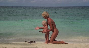 Movie still from “The Blue Lagoon” (1980), directed by Randal Kleiser – A woman and a child on the beach by the water; Wide shot, High angle