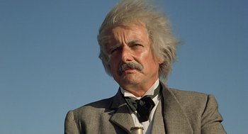 Movie still from “The Blue Lagoon” (1980), directed by Randal Kleiser – An older man with a white beard and a suit and tie; Close Up shot, Low angle