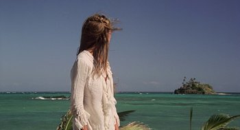 Movie still from “The Blue Lagoon” (1980), directed by Randal Kleiser – A woman standing on the beach looking at the ocean; Wide shot, Low angle