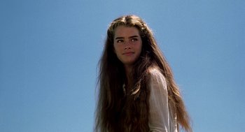 Movie still from “The Blue Lagoon” (1980), directed by Randal Kleiser – A woman with long hair is standing in the sun; Close Up shot, Low angle