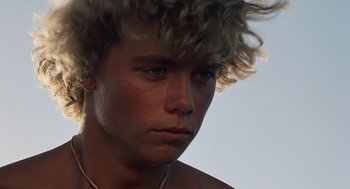 Movie still from “The Blue Lagoon” (1980), directed by Randal Kleiser – A person wearing a necklace; Close Up shot, Low angle