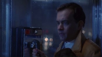 Movie still from “The Bonfire of the Vanities” (1990), directed by Brian De Palma – A man taking a picture of himself with a camera; Close Up shot, Low angle