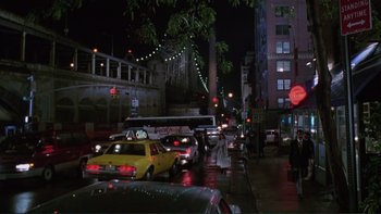 Movie still from “The Bonfire of the Vanities” (1990), directed by Brian De Palma – A city street filled with lots of traffic at night; Extreme Wide shot, High angle