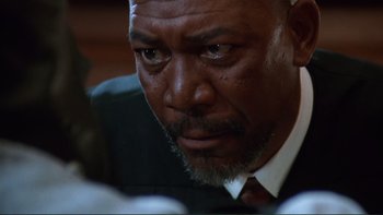 Movie still from “The Bonfire of the Vanities” (1990), directed by Brian De Palma – A man in a suit and tie looking at the camera; Close Up shot, Low angle
